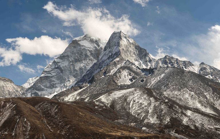 Stunning view of Mount Ama Dablam in the Himalayas with snow-covered peaks under a clear blue sky.